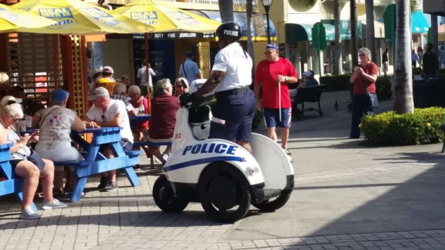 St Kitts and Nevis Police Officer riding a powered tricycle (Basseterre)