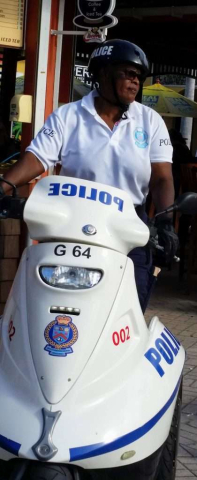 St Kitts and Nevis Police Officer riding a powered tricycle (Basseterre)